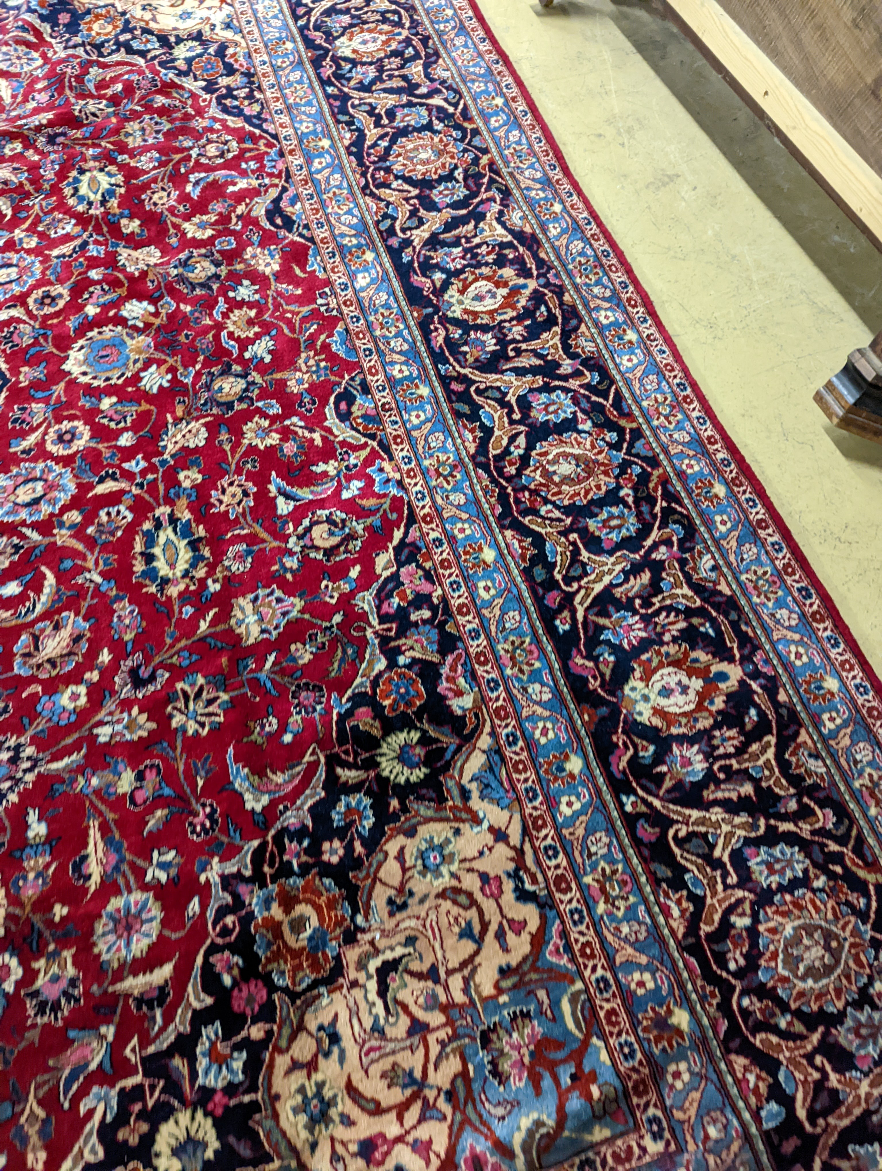 A Kashan burgundy ground carpet, 380 x 300cm